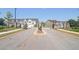 Gated community entrance with landscaping and townhomes visible at 179 Hampton Cir, Mcdonough, GA 30253
