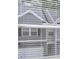 View of house exterior through blinds, showcasing a two-story home with gray siding and a pitched roof at 179 Hampton Cir, Mcdonough, GA 30253