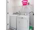 Laundry room with washer, dryer, and overhead shelving at 179 Hampton Cir, Mcdonough, GA 30253