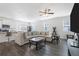 Open living room with L-shaped sofa, kitchen views, and hardwood floors at 179 Hampton Cir, Mcdonough, GA 30253