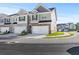 Modern townhome exterior with two-car garage and landscaping at 179 Hampton Cir, Mcdonough, GA 30253