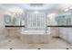 Luxurious bathroom featuring a jacuzzi tub with tiled floor and custom vanity with mirror at 3707 Peachtree Ne Rd # 1, Atlanta, GA 30319