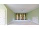 A light green bedroom with three windows covered with patterned curtains at 3707 Peachtree Ne Rd # 1, Atlanta, GA 30319