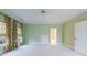 A light green bedroom features three windows with patterned curtains and a ceiling fan at 3707 Peachtree Ne Rd # 1, Atlanta, GA 30319