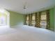 A spacious, light green bedroom features three windows with patterned drapes at 3707 Peachtree Ne Rd # 1, Atlanta, GA 30319