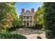 Stately brick home with manicured landscaping, columns, and a circular driveway at 3707 Peachtree Ne Rd # 1, Atlanta, GA 30319