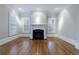 Inviting living room featuring hardwood floors, a fireplace, and white plantation shutters at 3707 Peachtree Ne Rd # 1, Atlanta, GA 30319