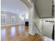 Open-concept living room with hardwood floors, fireplace, and stairs to the basement at 3707 Peachtree Ne Rd # 1, Atlanta, GA 30319