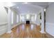 Large living space with hardwood floors, white columns, and a fireplace at 3707 Peachtree Ne Rd # 1, Atlanta, GA 30319