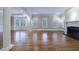 Spacious living area featuring hardwood floors, a fireplace, and large windows with plantation shutters at 3707 Peachtree Ne Rd # 1, Atlanta, GA 30319