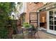 Outdoor brick patio with wrought-iron table set and lush greenery at 3707 Peachtree Ne Rd # 1, Atlanta, GA 30319