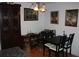 View of a dining room featuring hardwood floors, dark wooden furniture, and decorative paintings at 2697 Vinings Central Dr # 61, Atlanta, GA 30339