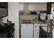 View of a laundry room featuring a washer, dryer, cabinets and tile floors at 2697 Vinings Central Dr # 61, Atlanta, GA 30339