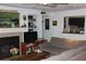Comfortable living room with fireplace, built-in shelves, and view into the kitchen at 2697 Vinings Central Dr # 61, Atlanta, GA 30339