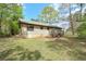 Spacious backyard showing the house, wooden deck, green grass, and natural surroundings at 798 Tommy Lee Cook Rd, Palmetto, GA 30268