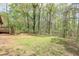 Large backyard with grass, trees, and a storage shed at 798 Tommy Lee Cook Rd, Palmetto, GA 30268