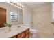 A practical full bathroom featuring a shower-tub combo and vanity with a wooden cabinet at 798 Tommy Lee Cook Rd, Palmetto, GA 30268