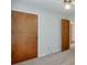 A carpeted bedroom with basic fixtures and several entrances and closet doors at 798 Tommy Lee Cook Rd, Palmetto, GA 30268