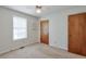 Cozy bedroom featuring neutral carpet, a ceiling fan, and a window providing natural light at 798 Tommy Lee Cook Rd, Palmetto, GA 30268