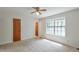 An interior bedroom with neutral carpet, a single closet and an exterior view from a large window at 798 Tommy Lee Cook Rd, Palmetto, GA 30268