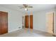 A modest bedroom featuring neutral carpet, ceiling fan, and dual closets at 798 Tommy Lee Cook Rd, Palmetto, GA 30268
