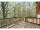 Wooden deck with railing, overlooking a wooded area and lush greenery at 798 Tommy Lee Cook Rd, Palmetto, GA 30268