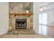 Living room features a stone fireplace with a wooden mantle and an open floor plan at 798 Tommy Lee Cook Rd, Palmetto, GA 30268