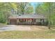 Single-story home featuring neutral siding, a chimney, and a well-kept front yard with trees at 798 Tommy Lee Cook Rd, Palmetto, GA 30268