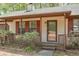 Close-up of front porch showing a lattice railing, and well-maintained landscaping at 798 Tommy Lee Cook Rd, Palmetto, GA 30268