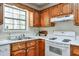 A well-lit kitchen with wood cabinets, white countertops, and modern appliances at 798 Tommy Lee Cook Rd, Palmetto, GA 30268
