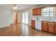 An airy kitchen and dining area featuring wood cabinets, and a sliding door to the outside at 798 Tommy Lee Cook Rd, Palmetto, GA 30268