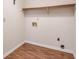 The laundry room features a shelf above the hookups and wood-look flooring at 798 Tommy Lee Cook Rd, Palmetto, GA 30268