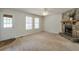 Bright living room with natural light, a stone fireplace, and carpet flooring at 798 Tommy Lee Cook Rd, Palmetto, GA 30268