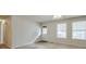 Neutral living room with carpet flooring, an exterior door, and large, bright windows at 798 Tommy Lee Cook Rd, Palmetto, GA 30268