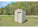Outdoor shed with a neutral door and walls, situated on a grassy lawn at 798 Tommy Lee Cook Rd, Palmetto, GA 30268