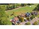 Aerial view showcases a large grassy backyard, golf course views and neighboring homes in a desirable neighborhood at 8150 Albritton Downs, Cumming, GA 30041