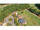 An aerial shot of the property shows the home's proximity to the golf course, mature trees, and neighborhood at 8150 Albritton Downs, Cumming, GA 30041