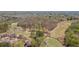 Expansive aerial view of golf course community surrounded by lush trees, green fairway and well-maintained homes at 8150 Albritton Downs, Cumming, GA 30041