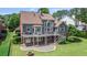 A beautifully landscaped backyard features a spacious deck, patio, and a charming fire pit for relaxing evenings at 8150 Albritton Downs, Cumming, GA 30041