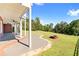 Lush backyard featuring covered patio and brick fire pit, ideal for entertaining at 8150 Albritton Downs, Cumming, GA 30041