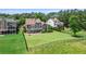 The backyard features a spacious lawn, multilevel deck, patio, and fire pit, ideal for outdoor activities and relaxation at 8150 Albritton Downs, Cumming, GA 30041