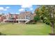 Lovely view of backyard featuring a deck and well-manicured lawn at 8150 Albritton Downs, Cumming, GA 30041