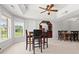Basement entertaining area featuring a dining table, bar with wine rack, and a ceiling fan at 8150 Albritton Downs, Cumming, GA 30041