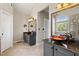Bright bathroom featuring double vanities with vessel sinks, granite counters, and modern fixtures at 8150 Albritton Downs, Cumming, GA 30041