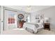 Cozy bedroom with two windows, dresser, and bedside table; light and airy feel at 8150 Albritton Downs, Cumming, GA 30041