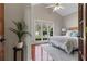 Inviting bedroom featuring neutral tones, vaulted ceiling, hardwood floors, and large windows offering a tranquil view at 8150 Albritton Downs, Cumming, GA 30041