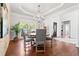 Elegant dining room featuring a classic chandelier, neutral tones, and large windows for an inviting atmosphere at 8150 Albritton Downs, Cumming, GA 30041