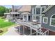 Stunning view of the home's back exterior featuring a multi-level deck and large windows at 8150 Albritton Downs, Cumming, GA 30041