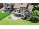 Rear exterior view highlighting a spacious deck, outdoor seating, and landscaped yard at 8150 Albritton Downs, Cumming, GA 30041