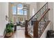 Elegant foyer with soaring ceilings, a grand staircase, and large windows offering abundant natural light and scenic views at 8150 Albritton Downs, Cumming, GA 30041